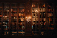 A room filled with lots of books and a chandelier