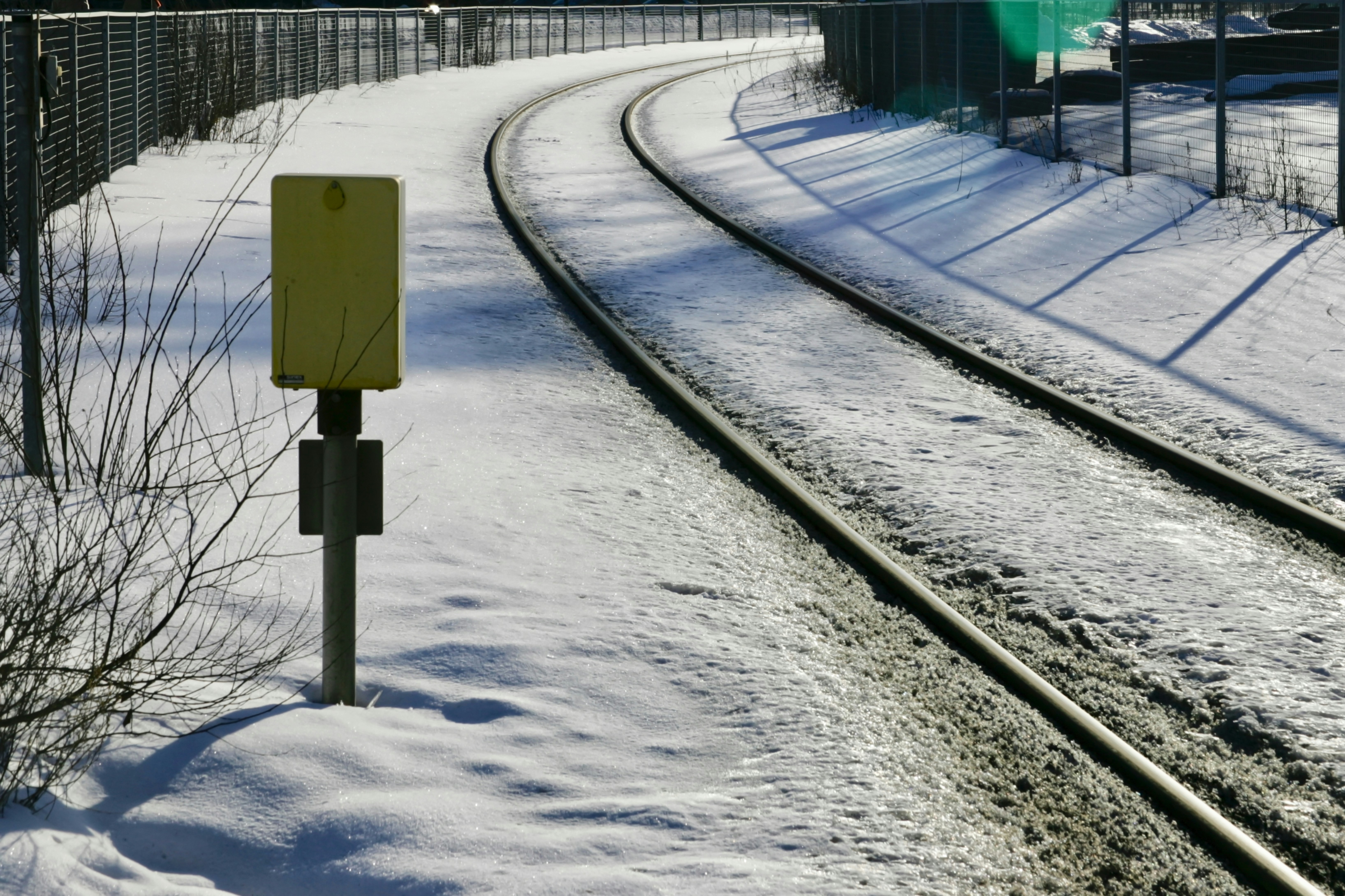 A train traveling down tracks in the snow