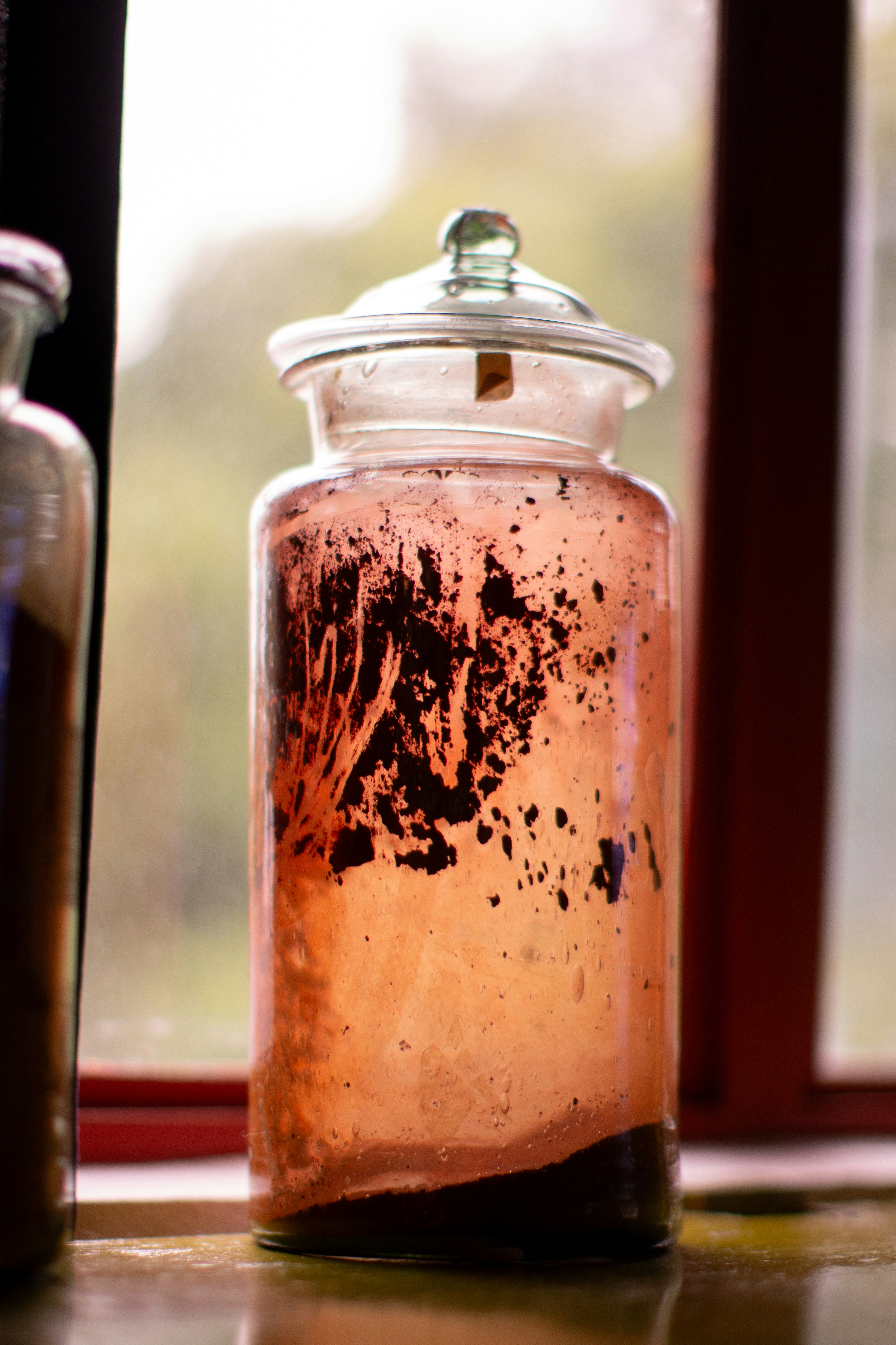 A jar filled with liquid sitting on top of a table