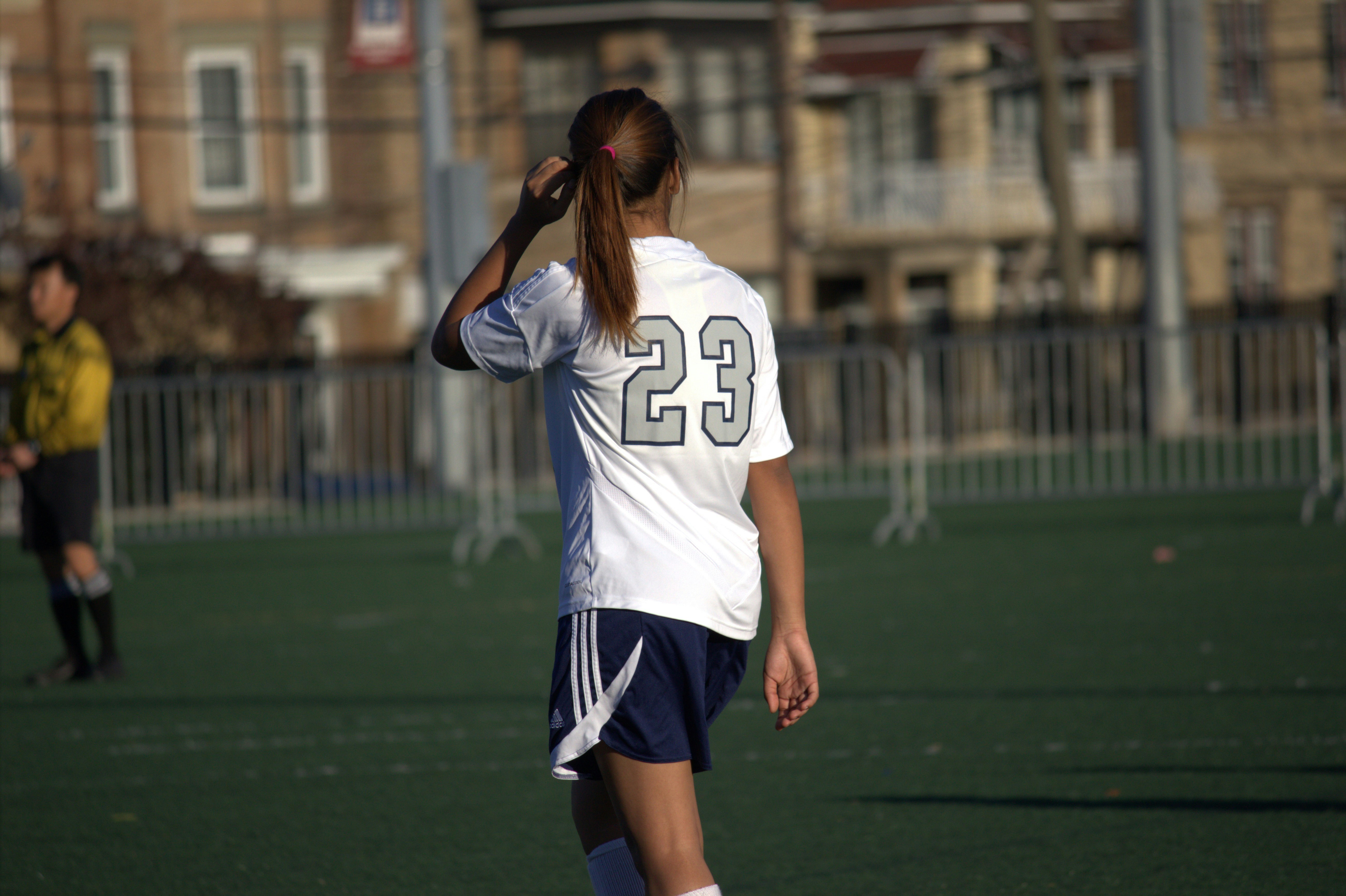 A high school soccer player in action on the field.