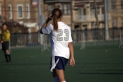 A woman standing on top of a soccer field