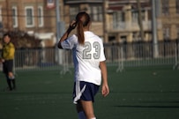 A woman standing on top of a soccer field