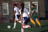 A group of young women playing a game of soccer
