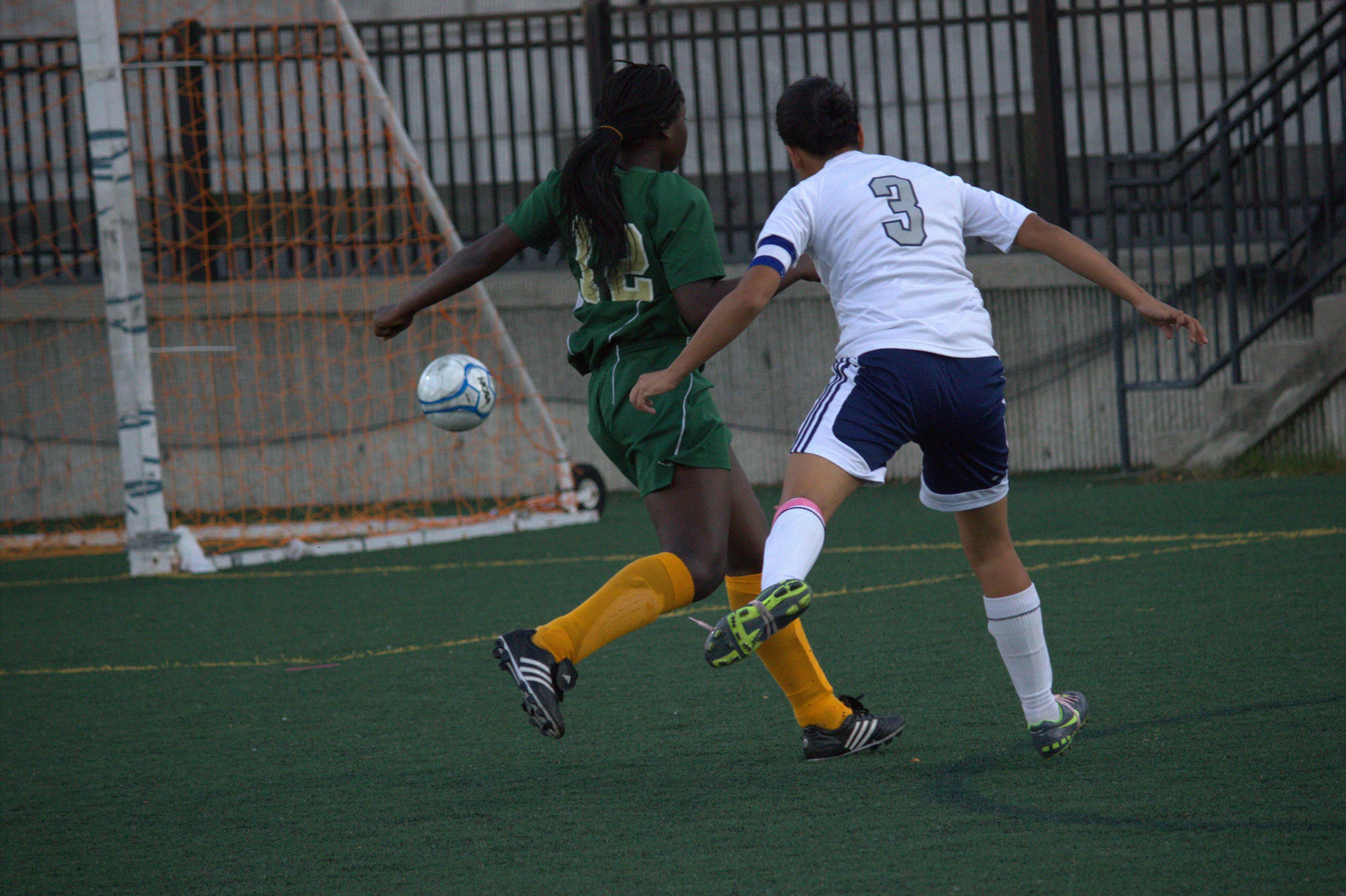 4fc88364682e45ed - A group of young men playing a game of soccer