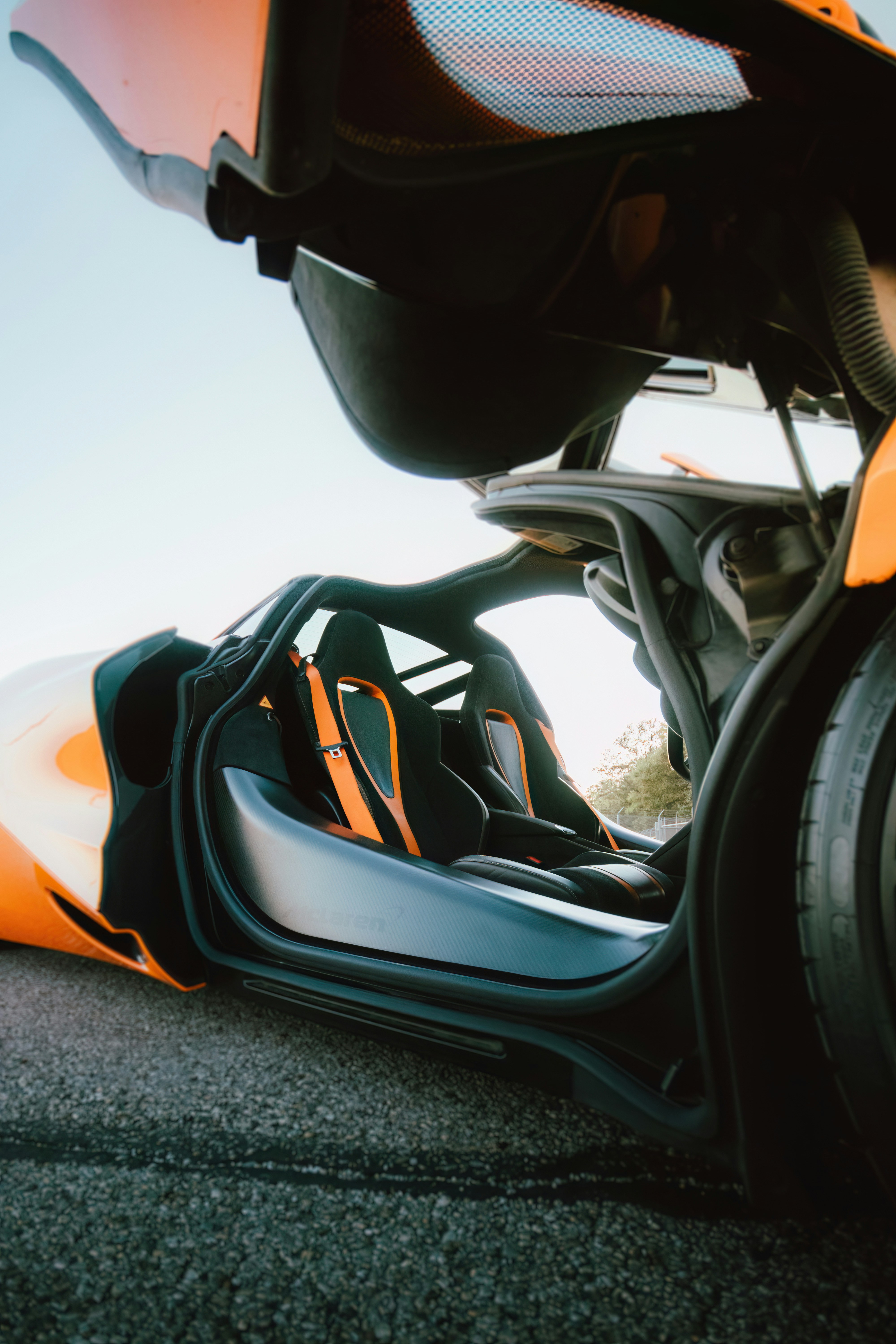 A close up of an orange and black motorcycle