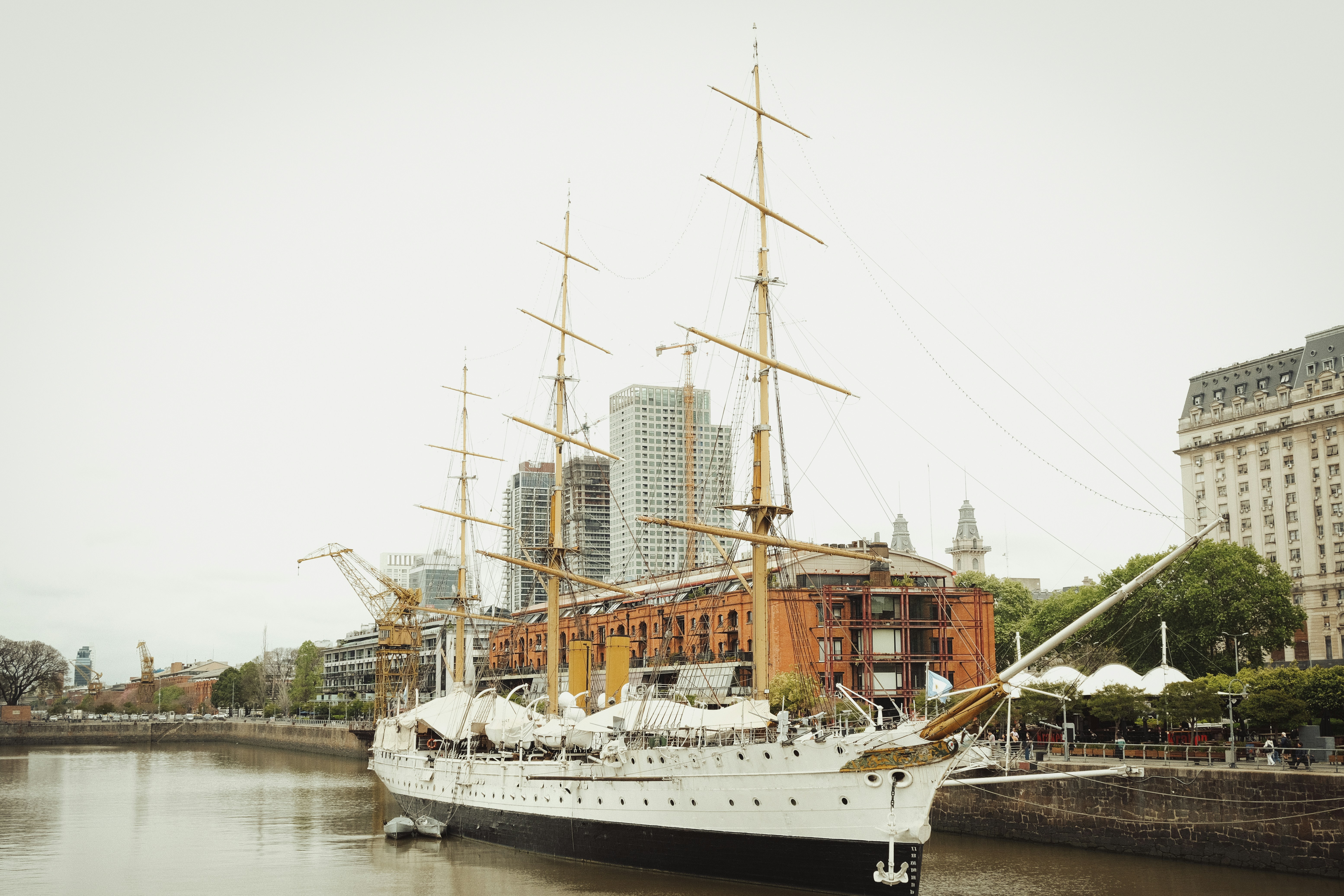 A large white boat floating on top of a river