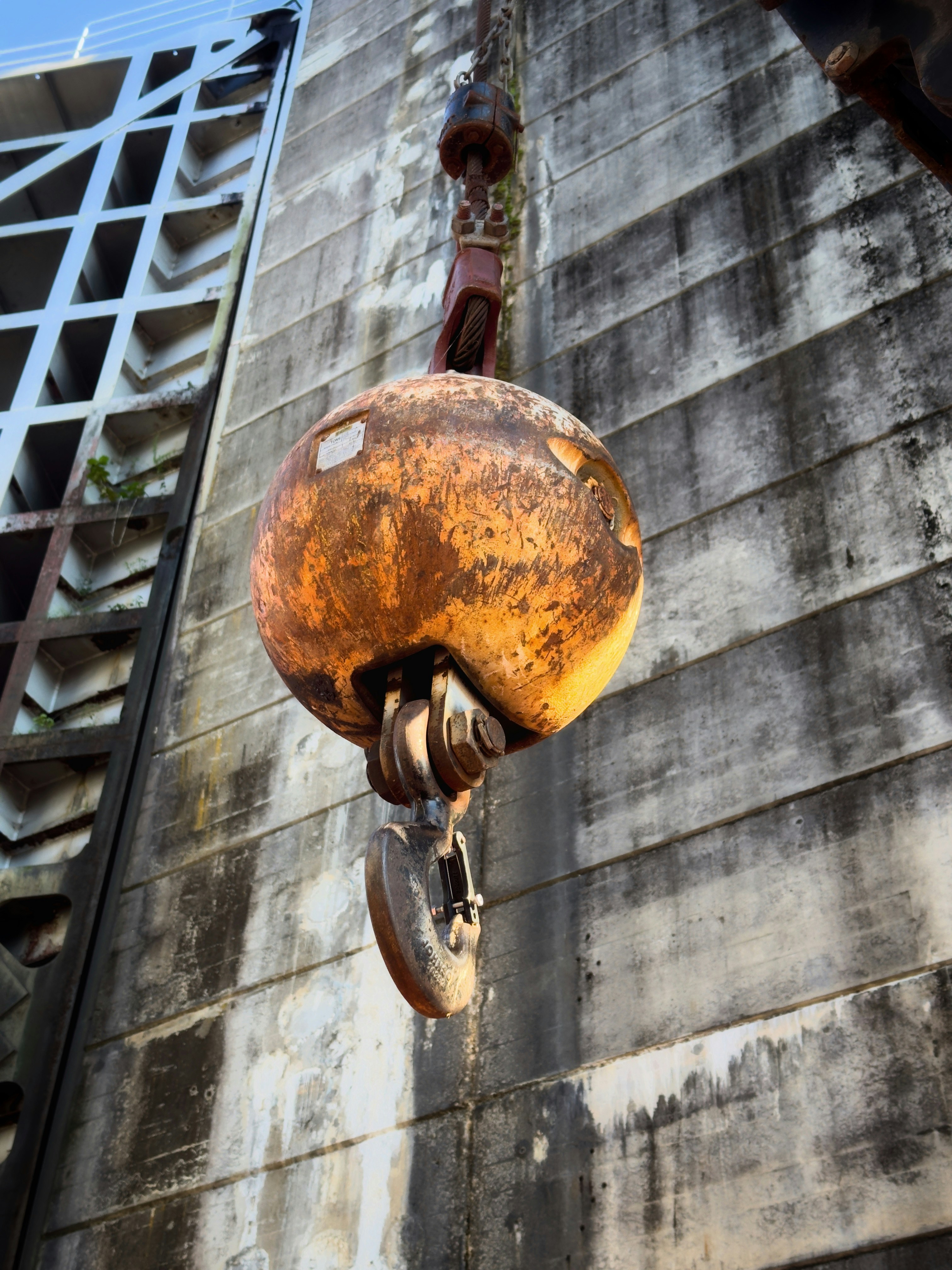 A crane is lifting a large piece of metal