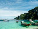 A group of boats floating on top of a body of water