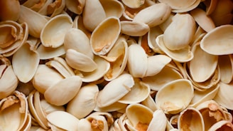 A pile of pistachio shells sitting on top of each other