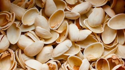 A pile of pistachio shells sitting on top of each other