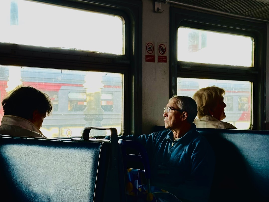 A group of people sitting on a bus next to each other,