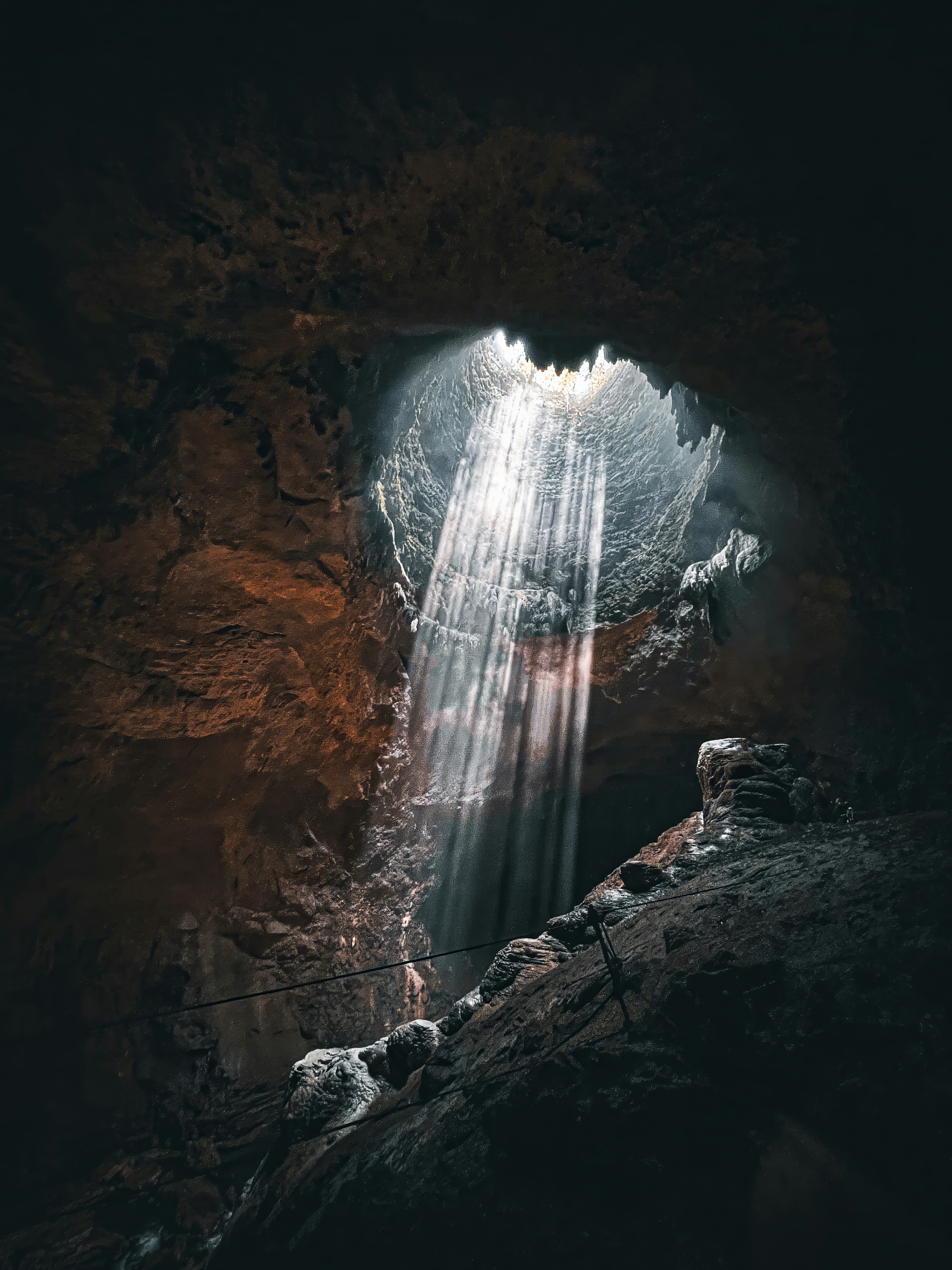 Light piercing through dark cave opening