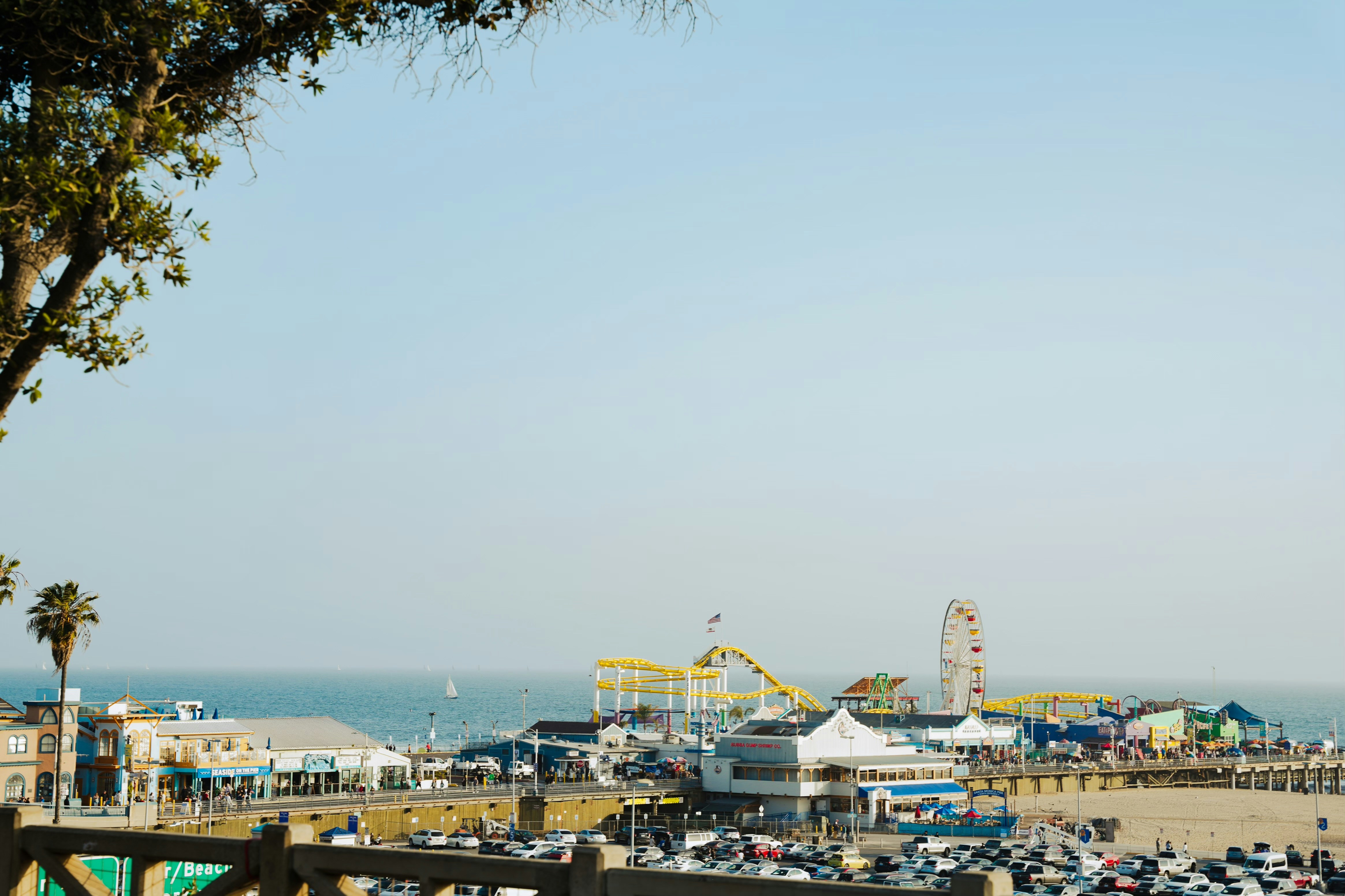 A view of a beach with a ferris wheel in the background