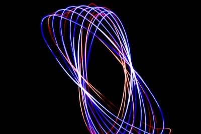A long exposure photo of a blue and red light
