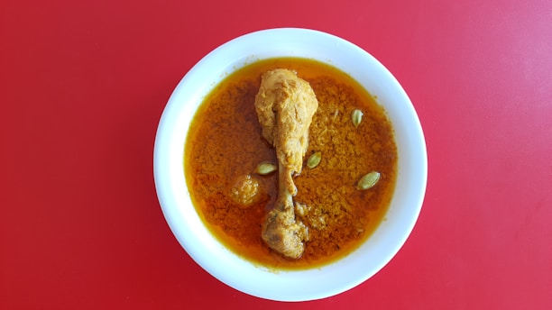 A bowl of soup on a red table