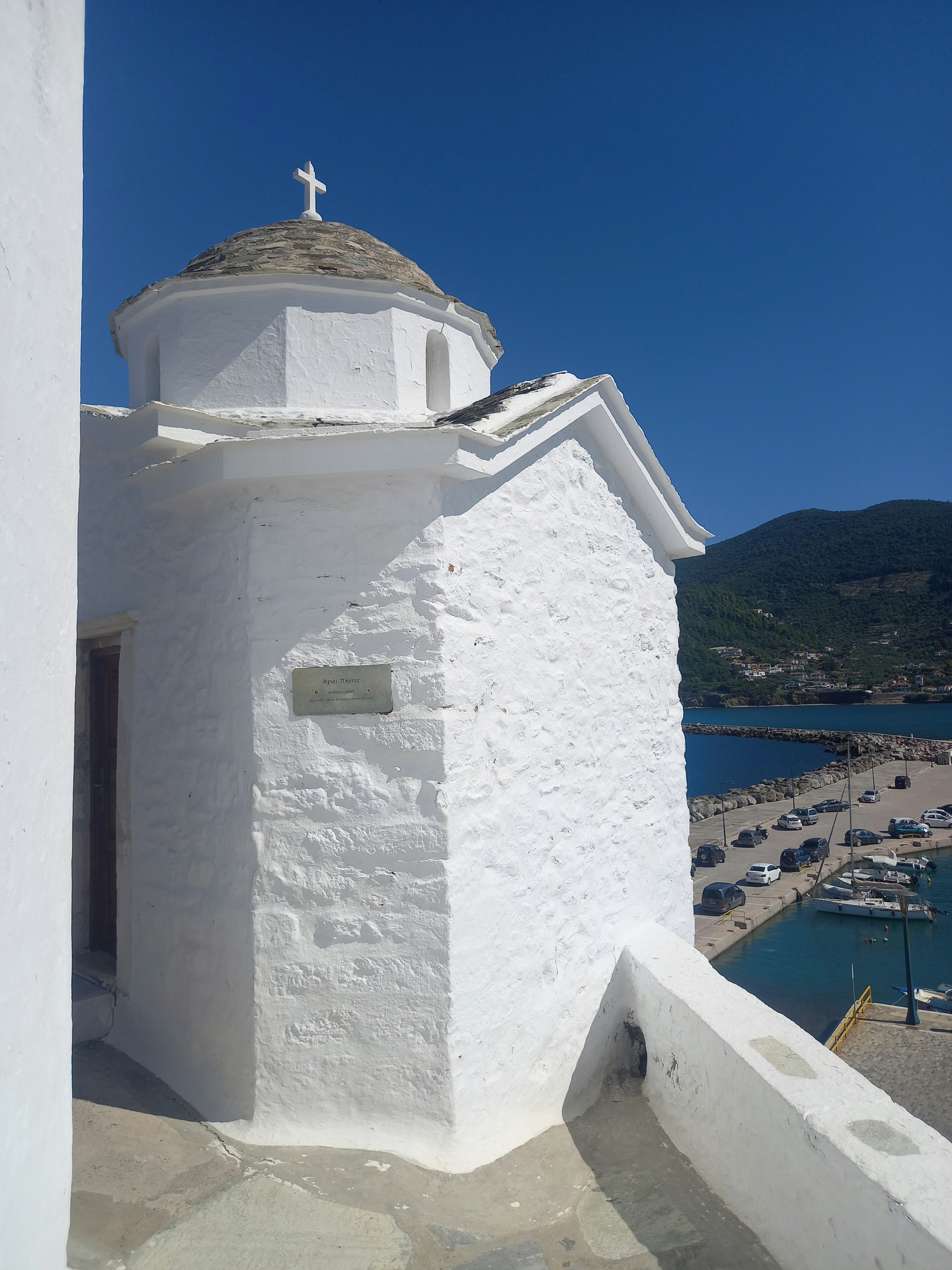 A white building with a cross on top of it