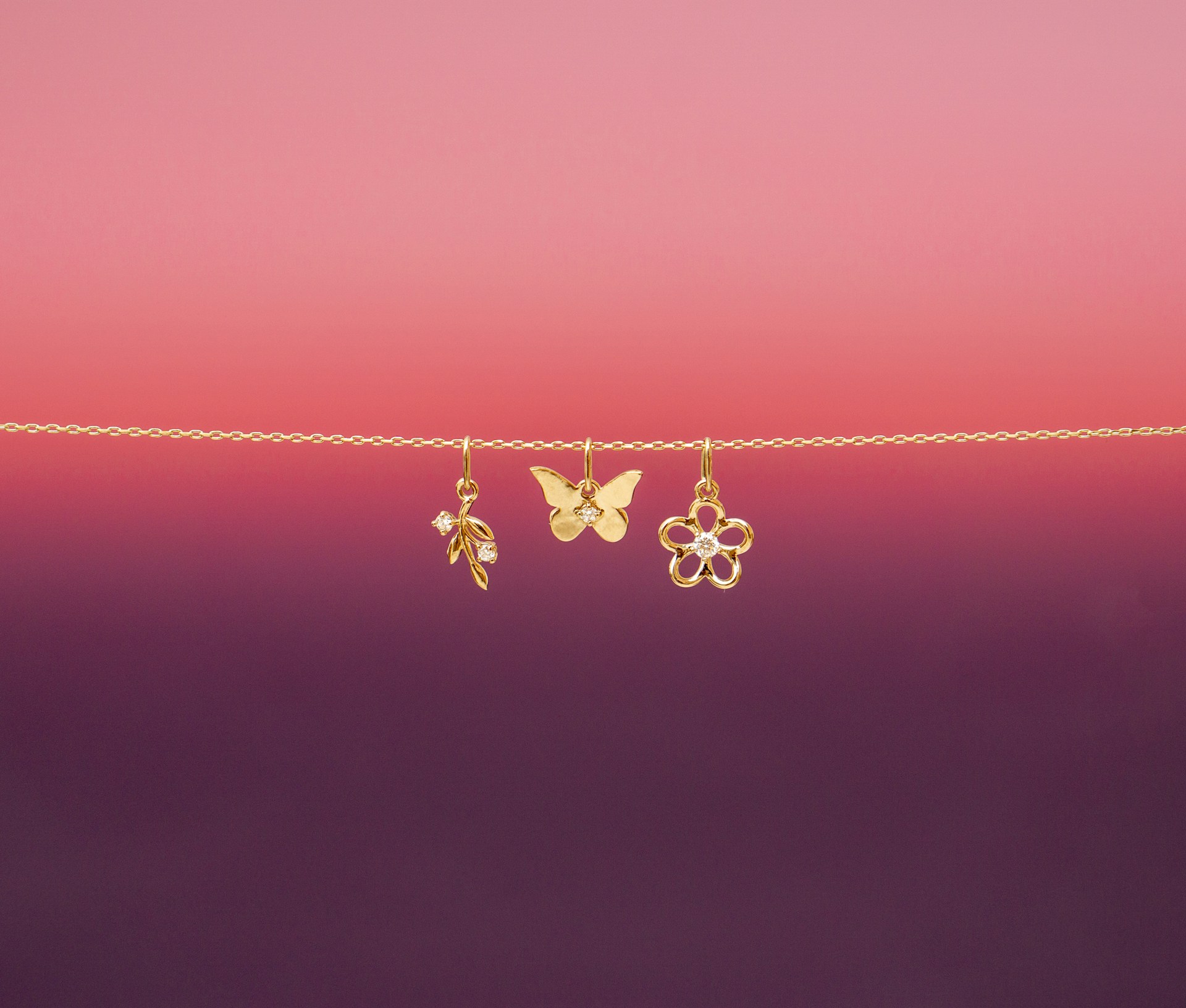 A pair of gold earrings hanging from a string