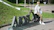 A woman sitting on the letters of a sign