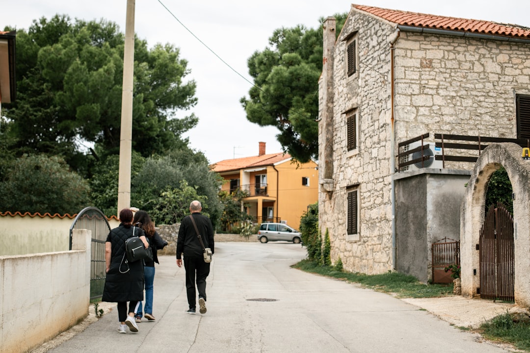 A group of people walking down a street,