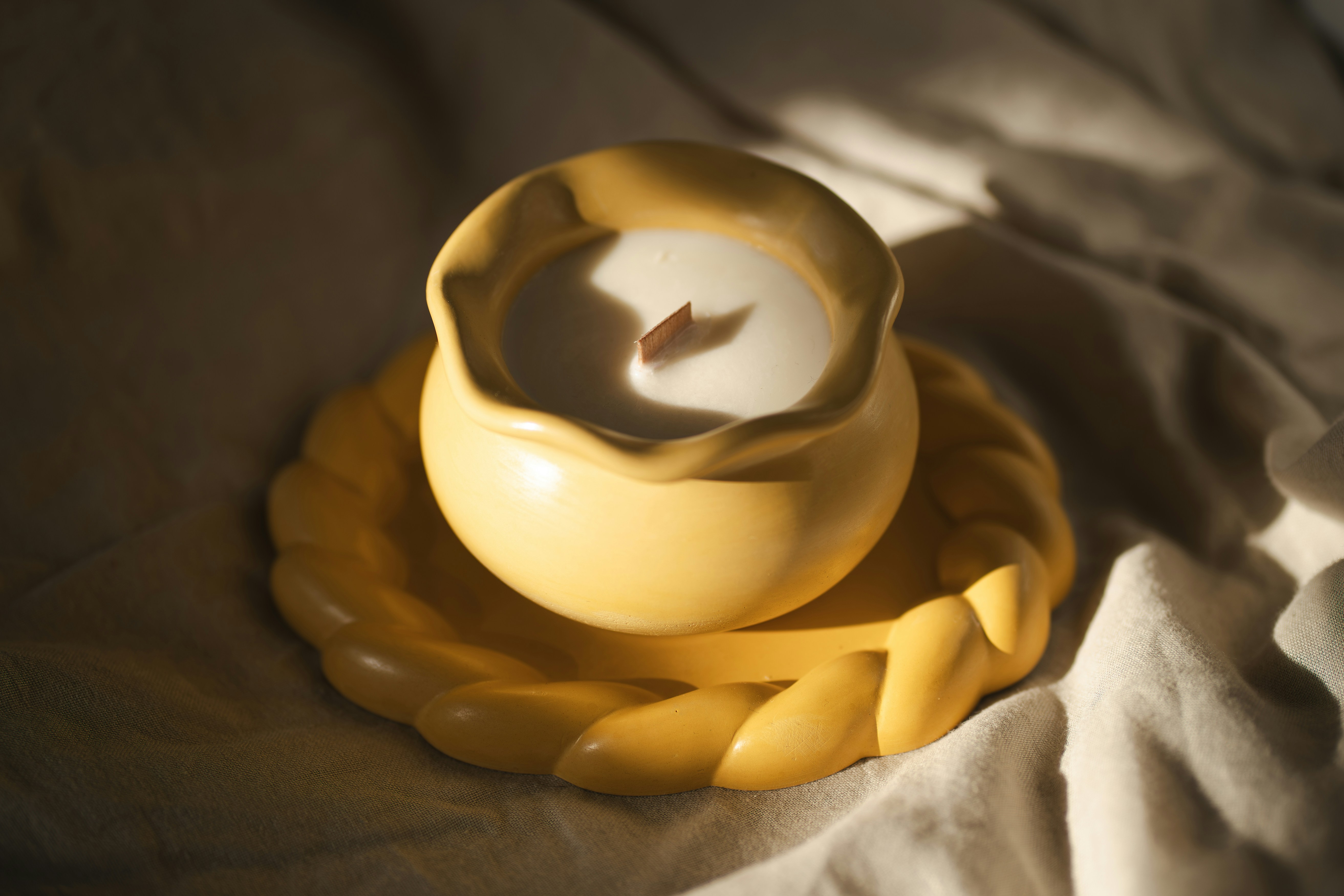 Image of a steaming cup of chamomile tea on a bedside table