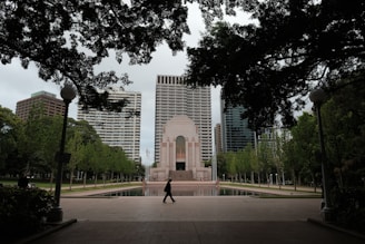 A person walking in front of a tall building