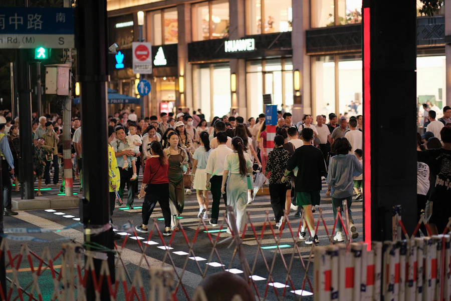Evening crowd crossing Nanjing Road in Shanghai, phones in hand