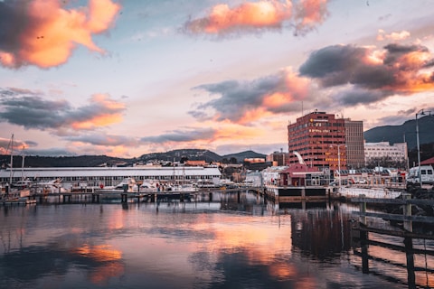 A harbor filled with lots of boats under a cloudy sky