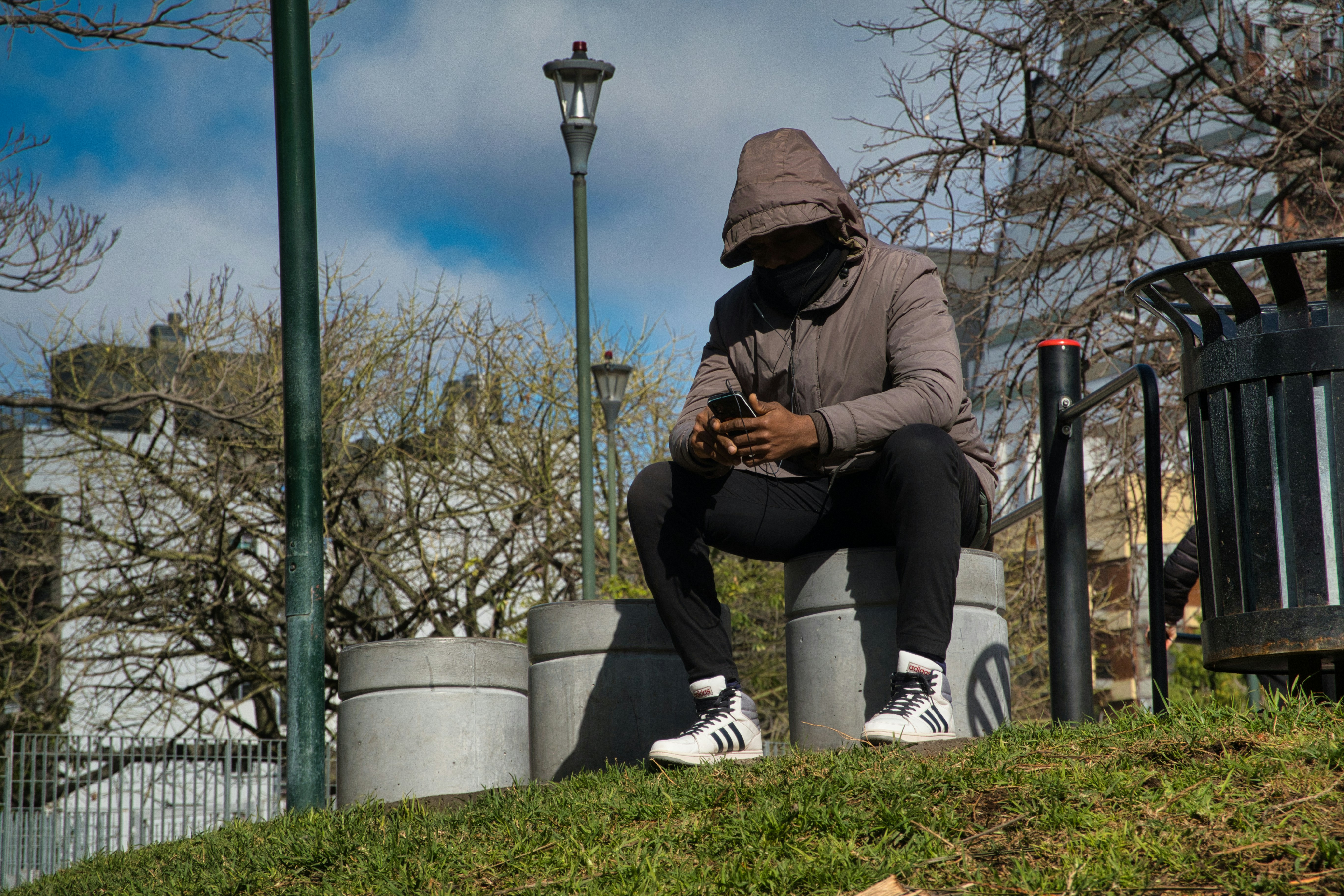 A person sitting on a bench with a cell phone
