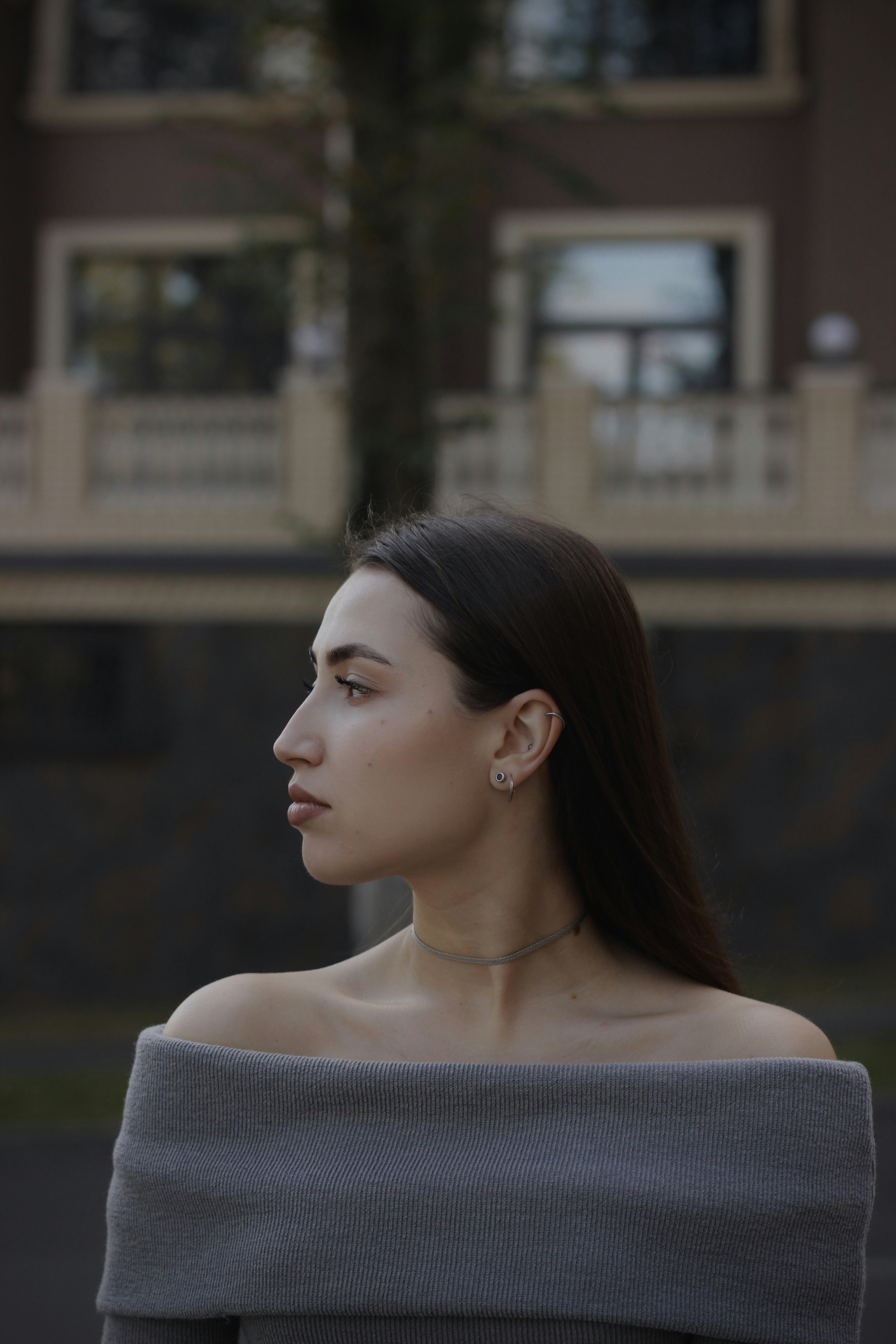A woman in a gray off the shoulder top