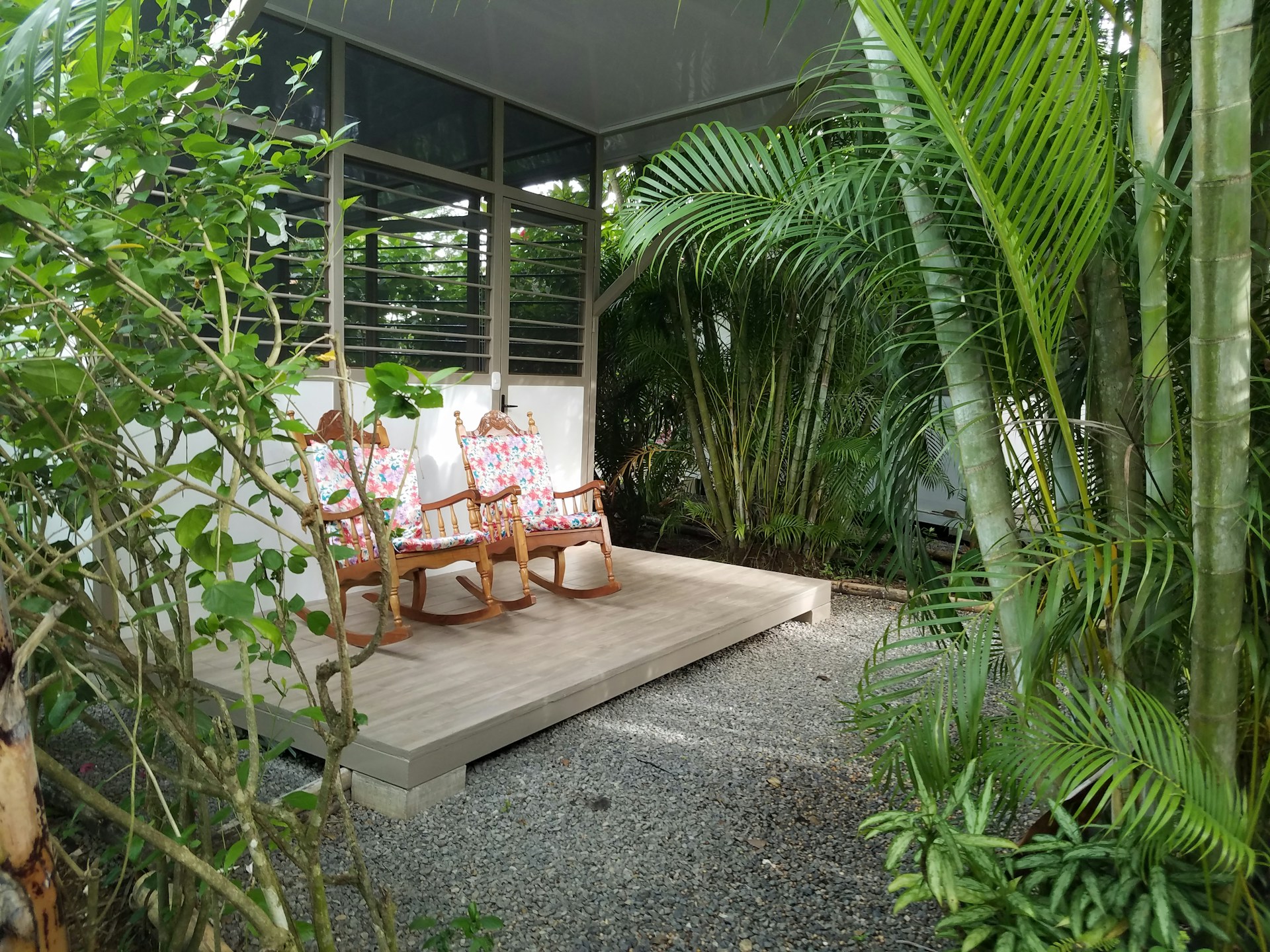 A covered patio with a table and chairs