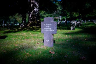 A cemetery with a sign in the grass