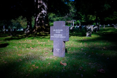 A cemetery with a sign in the grass