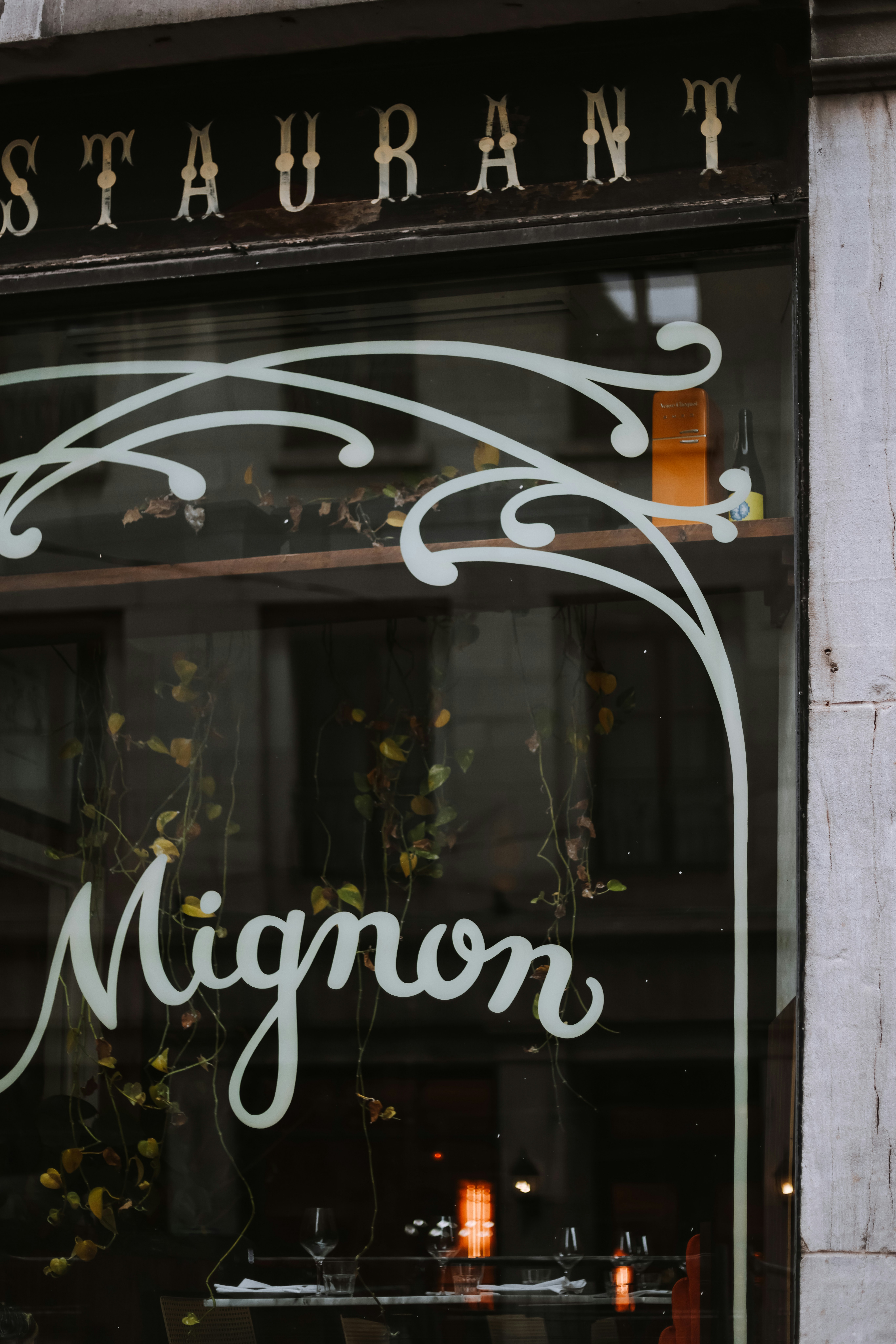 A restaurant window with a sign on it