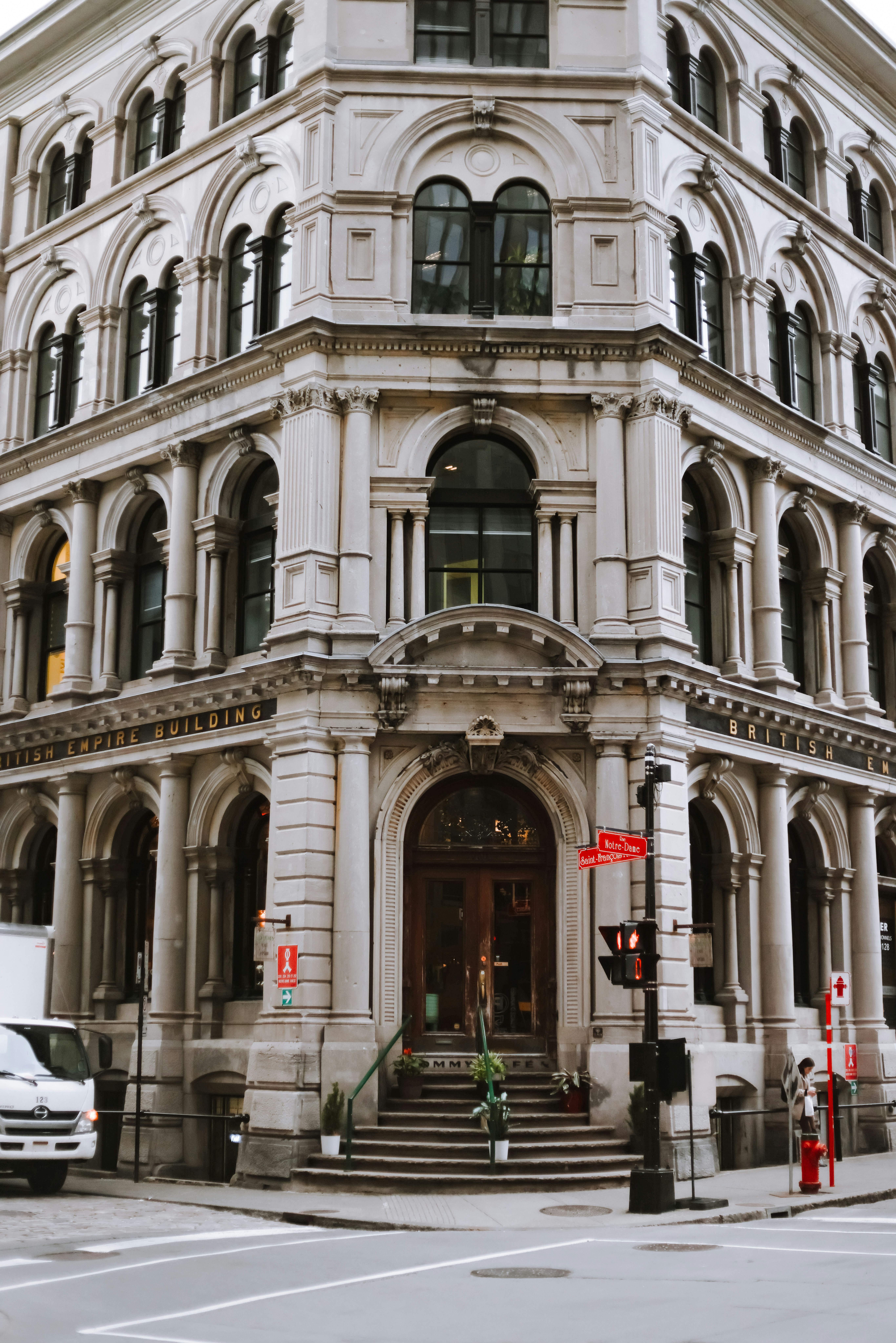 A large white building sitting on the corner of a street