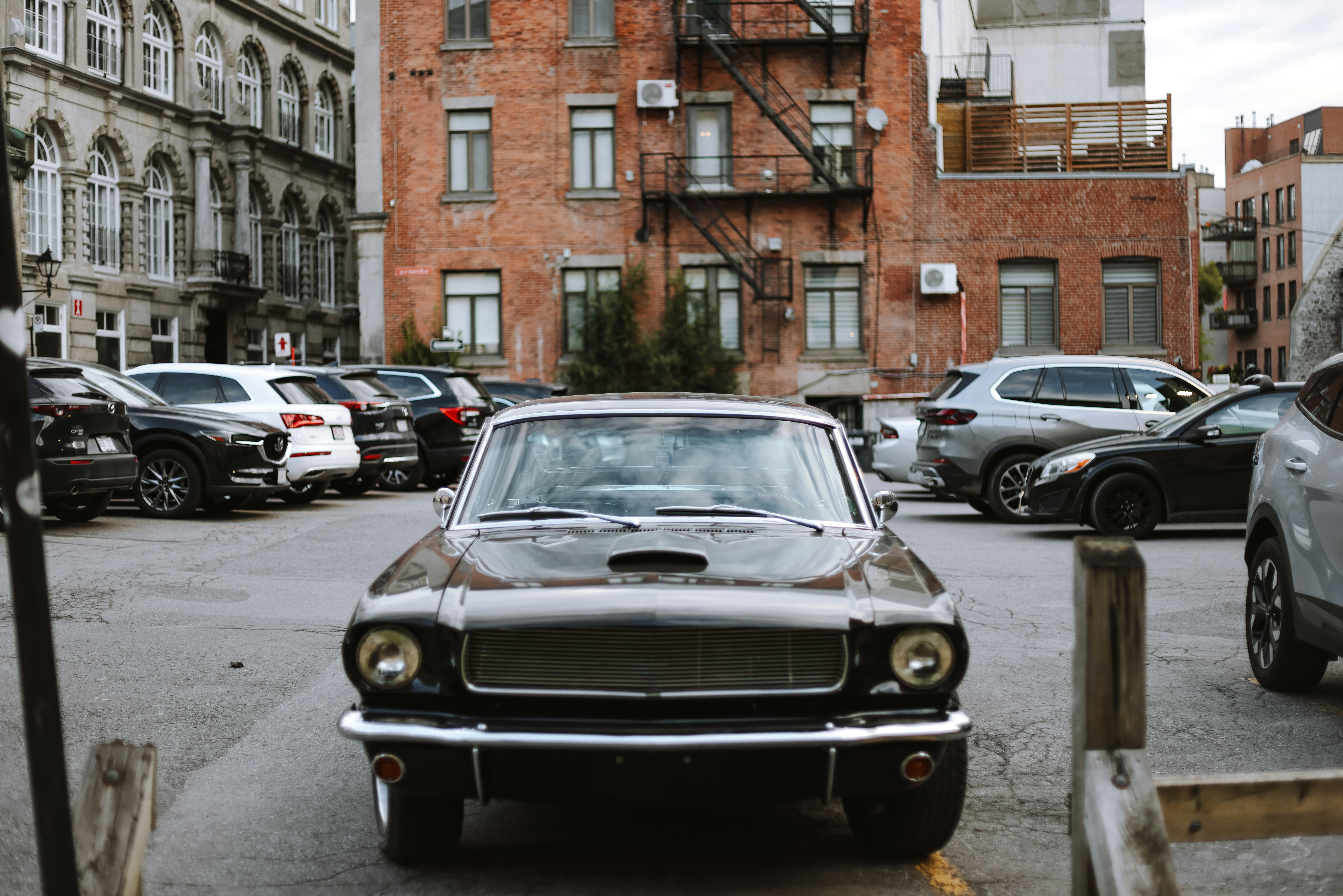 A car parked in a parking lot next to a parking meter