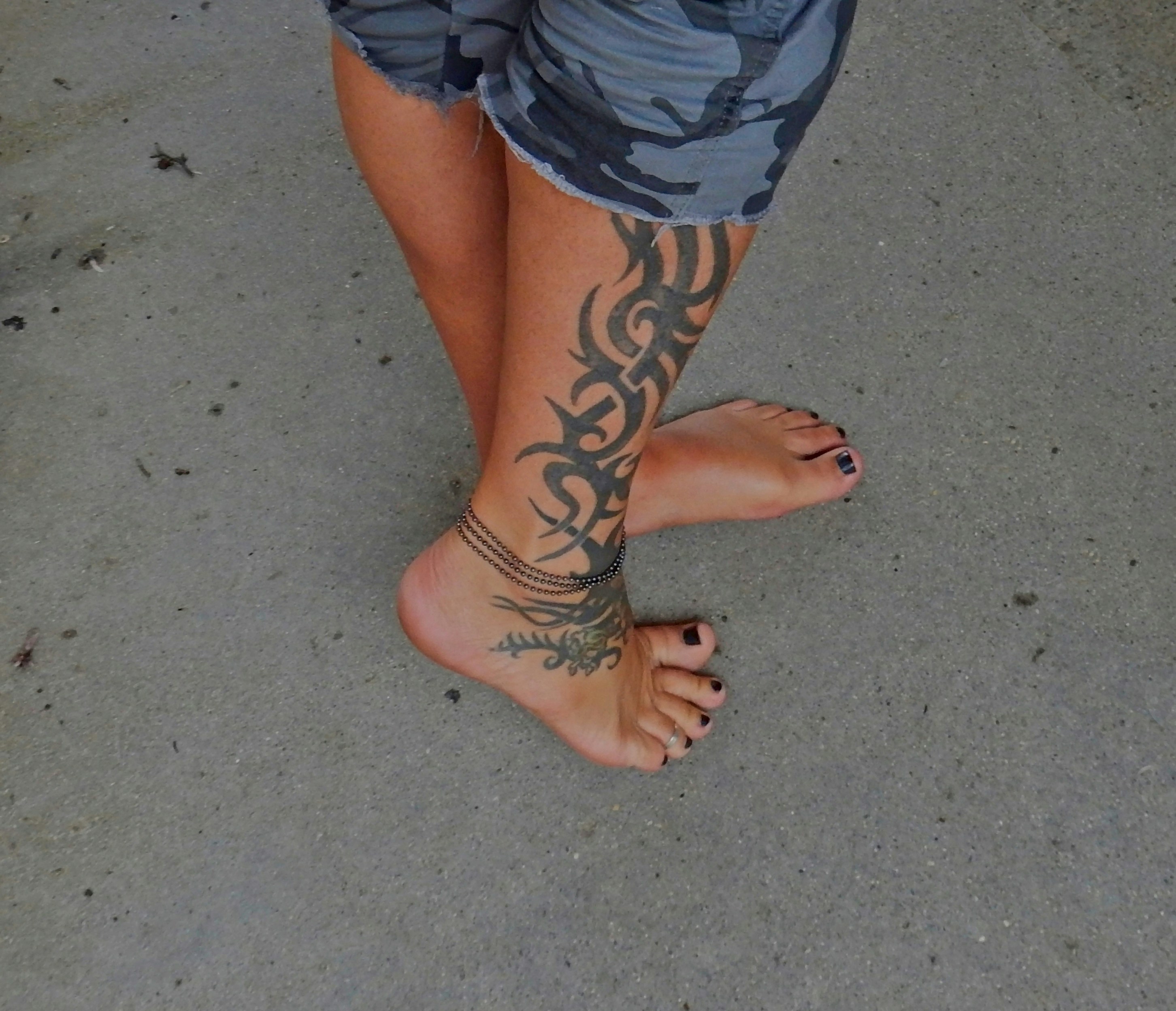 A woman's legs with tattoos on them