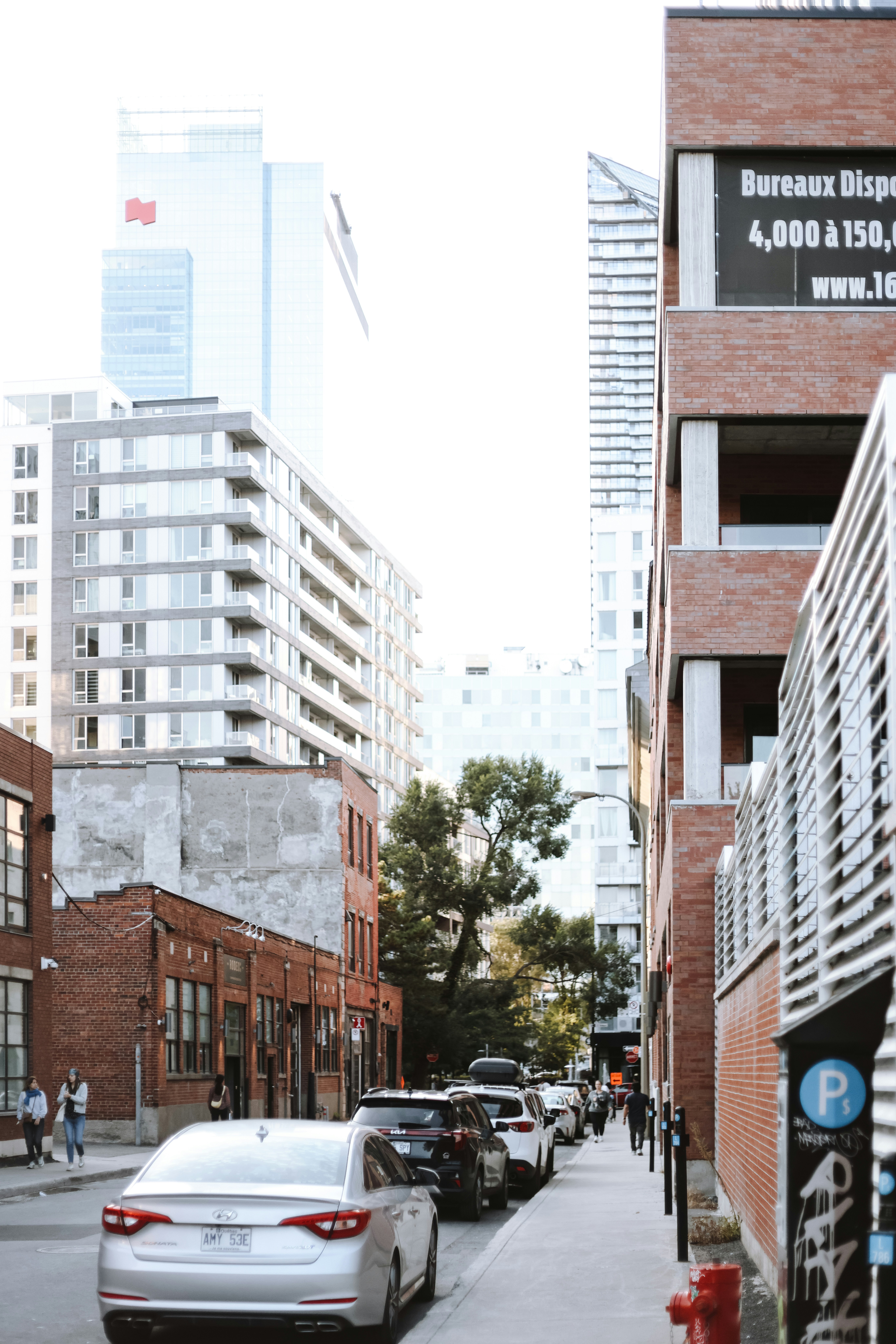 A city street with cars parked on the side of it