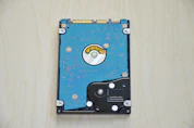 A hard drive sitting on top of a wooden table