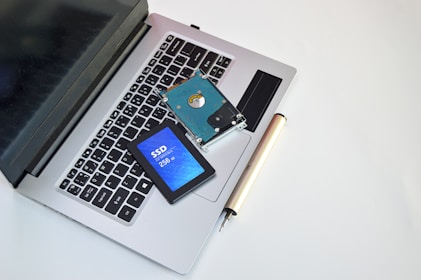An open laptop computer sitting on top of a white table