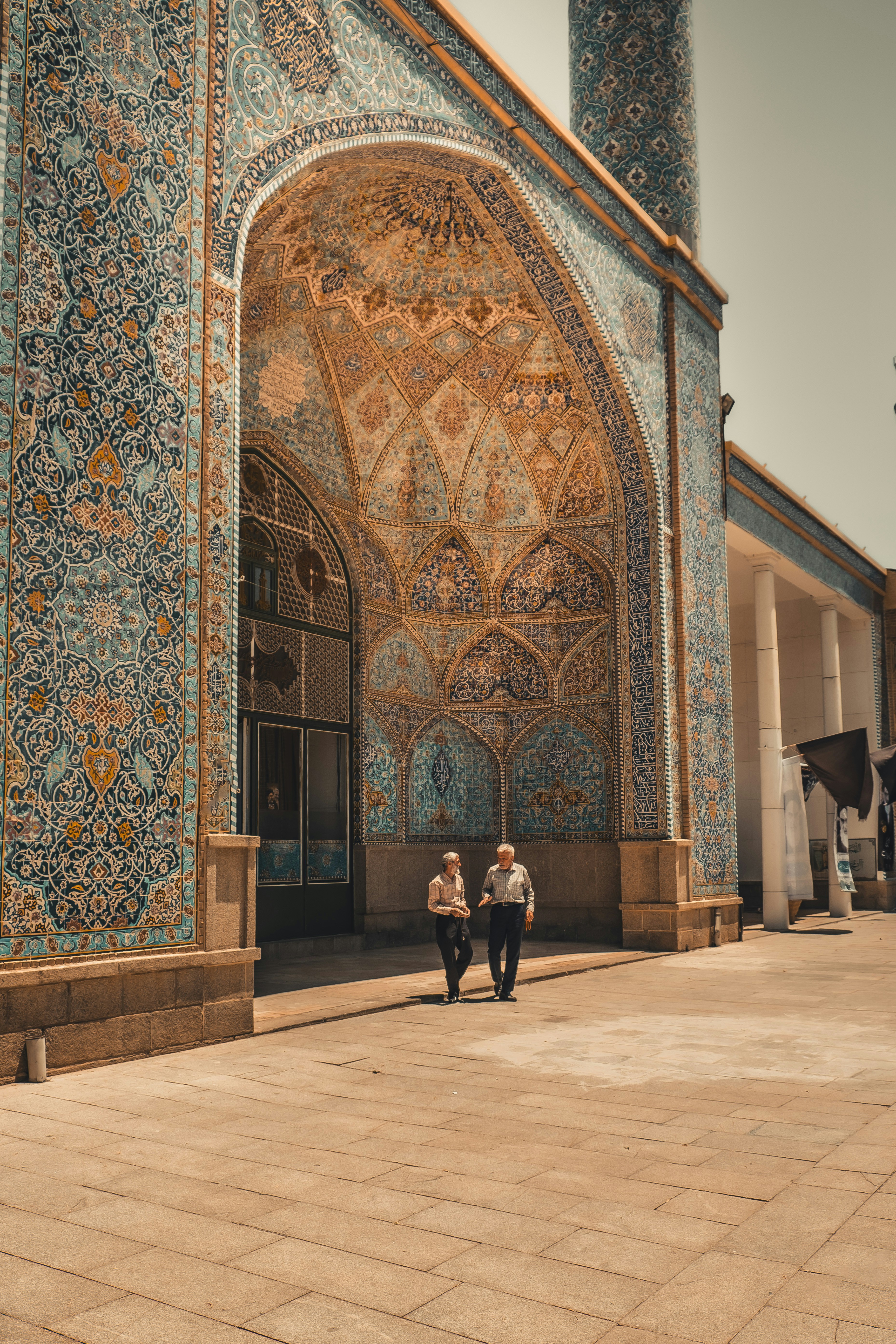 A couple of people that are standing in front of a building