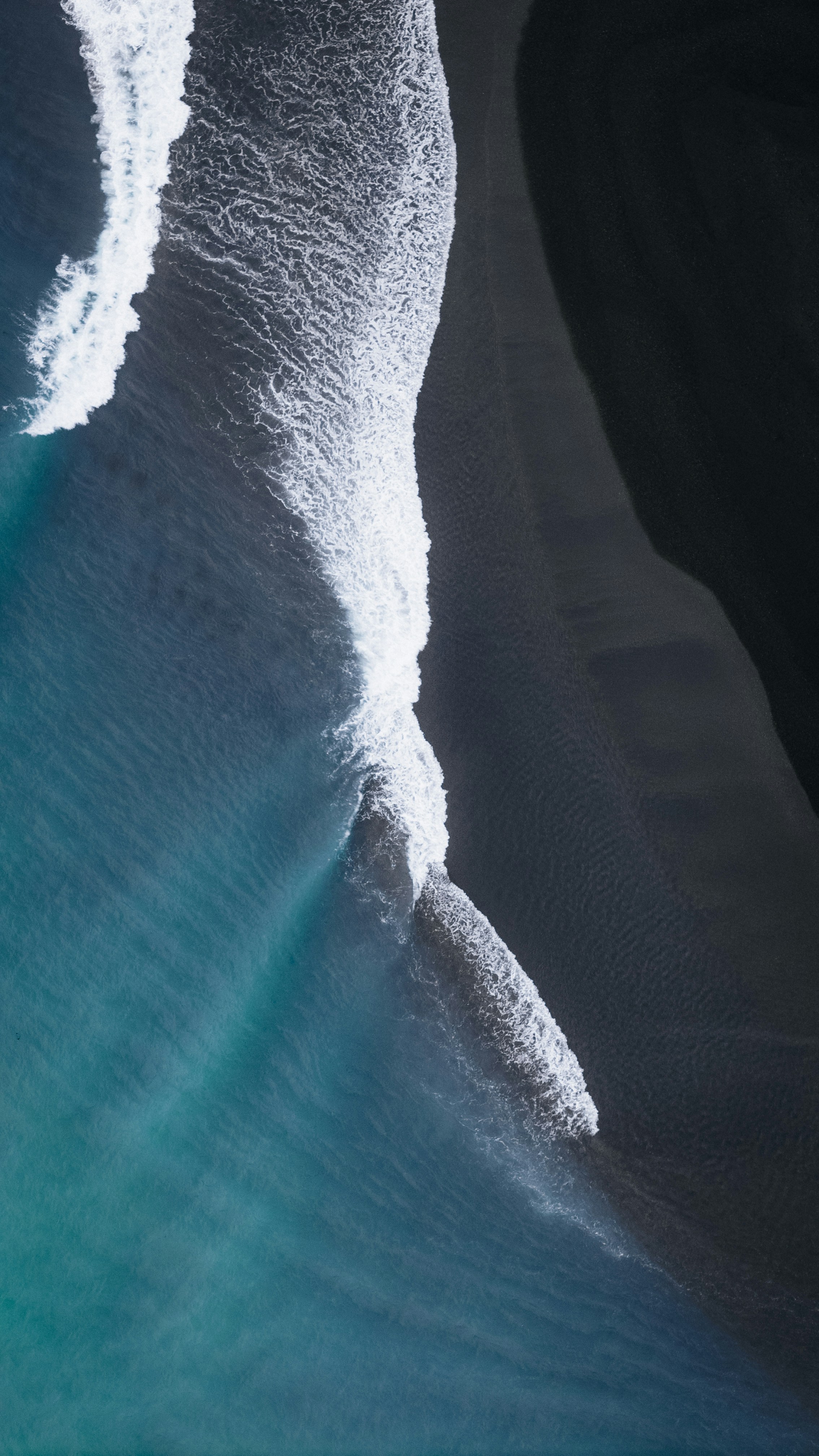 A person riding a snowboard down a snow covered slope