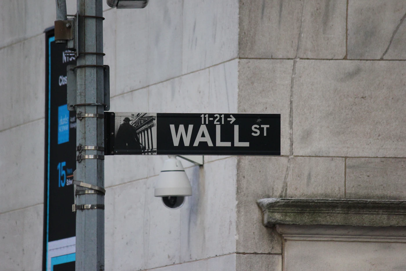 A Wall Street street sign on a building corner in New York