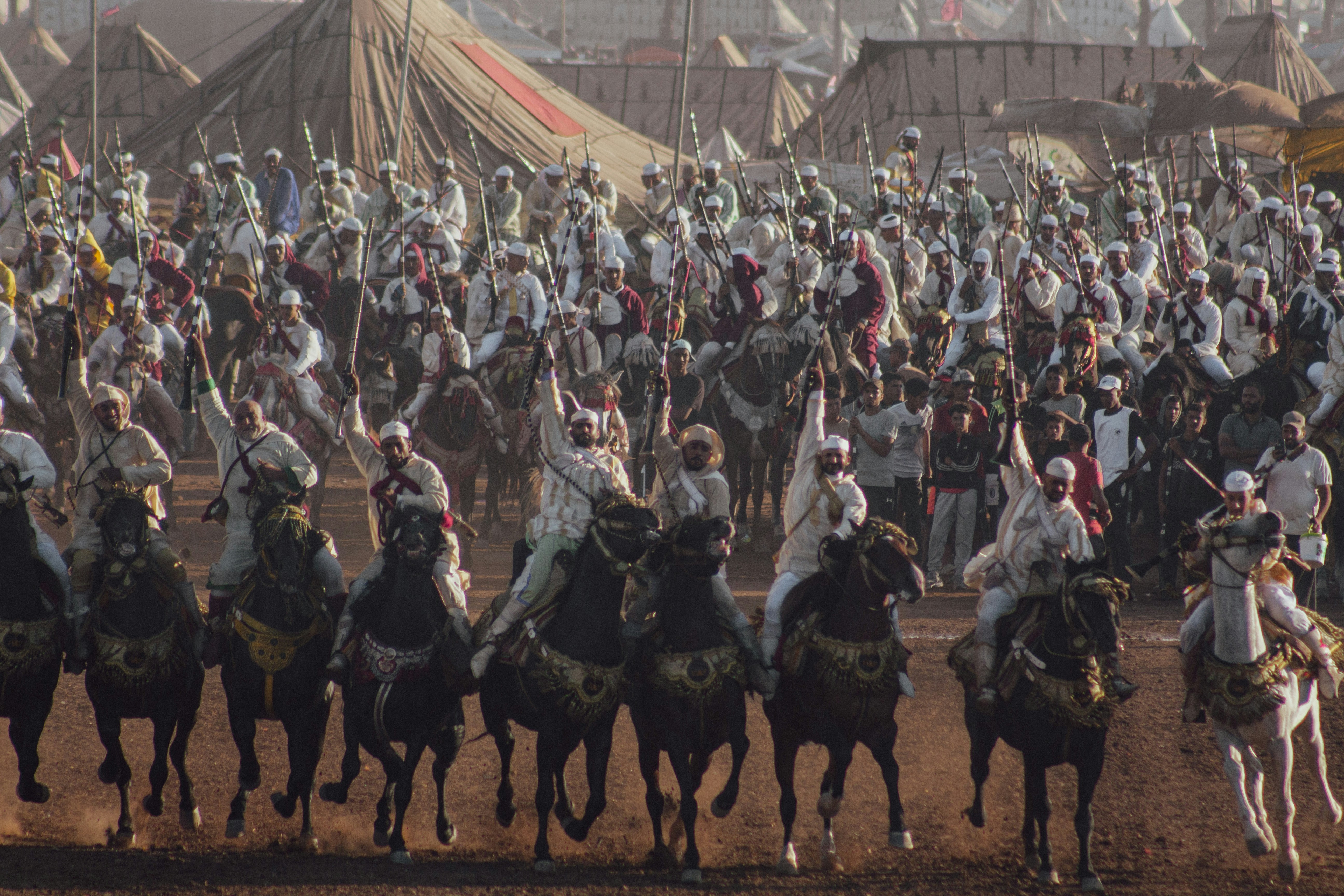 A large group of people riding on the backs of horses