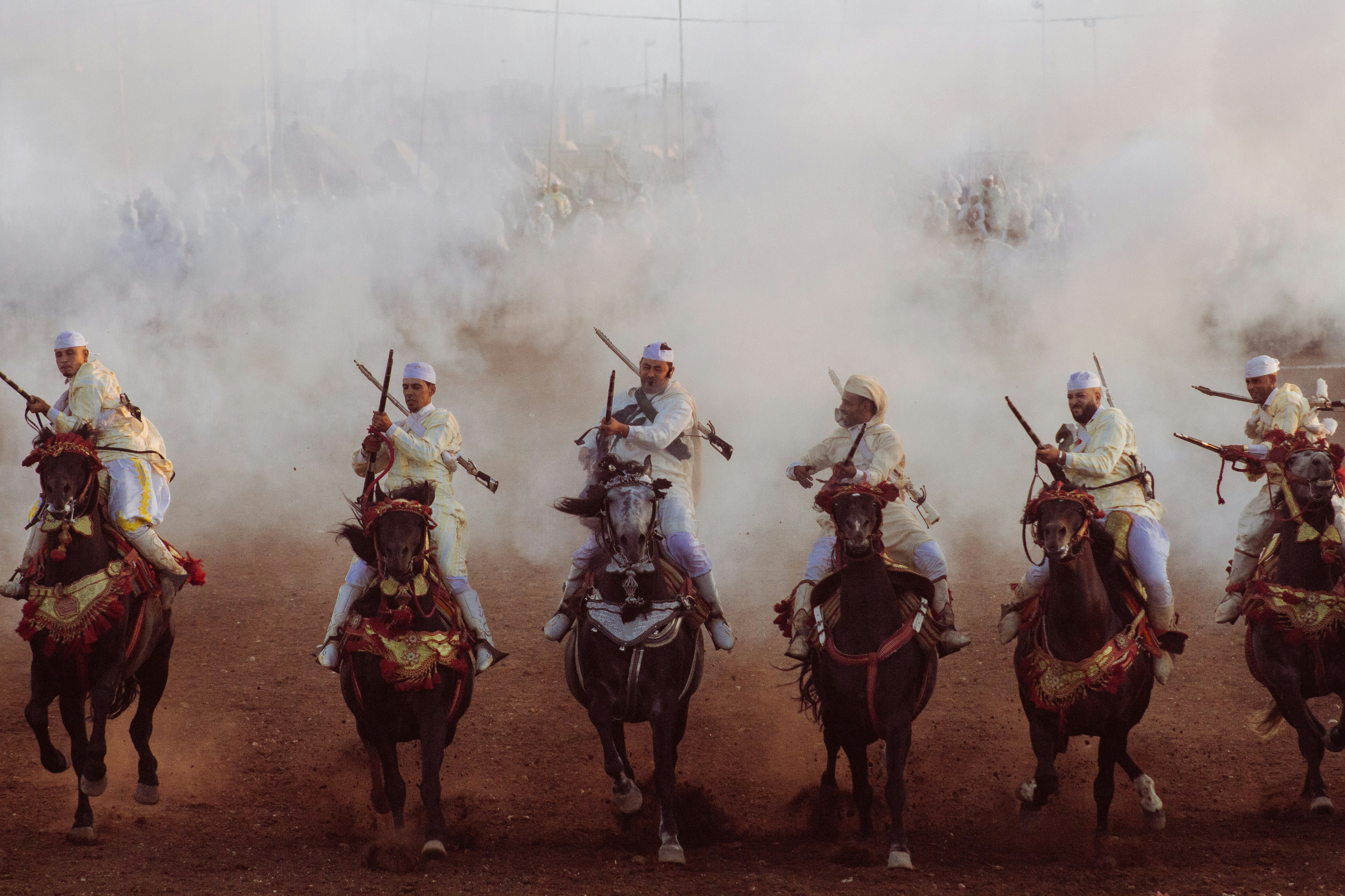 A group of men riding on the backs of horses