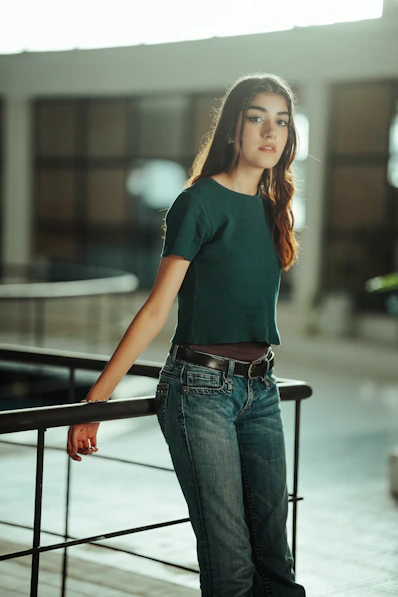 A woman leaning on a rail in a building