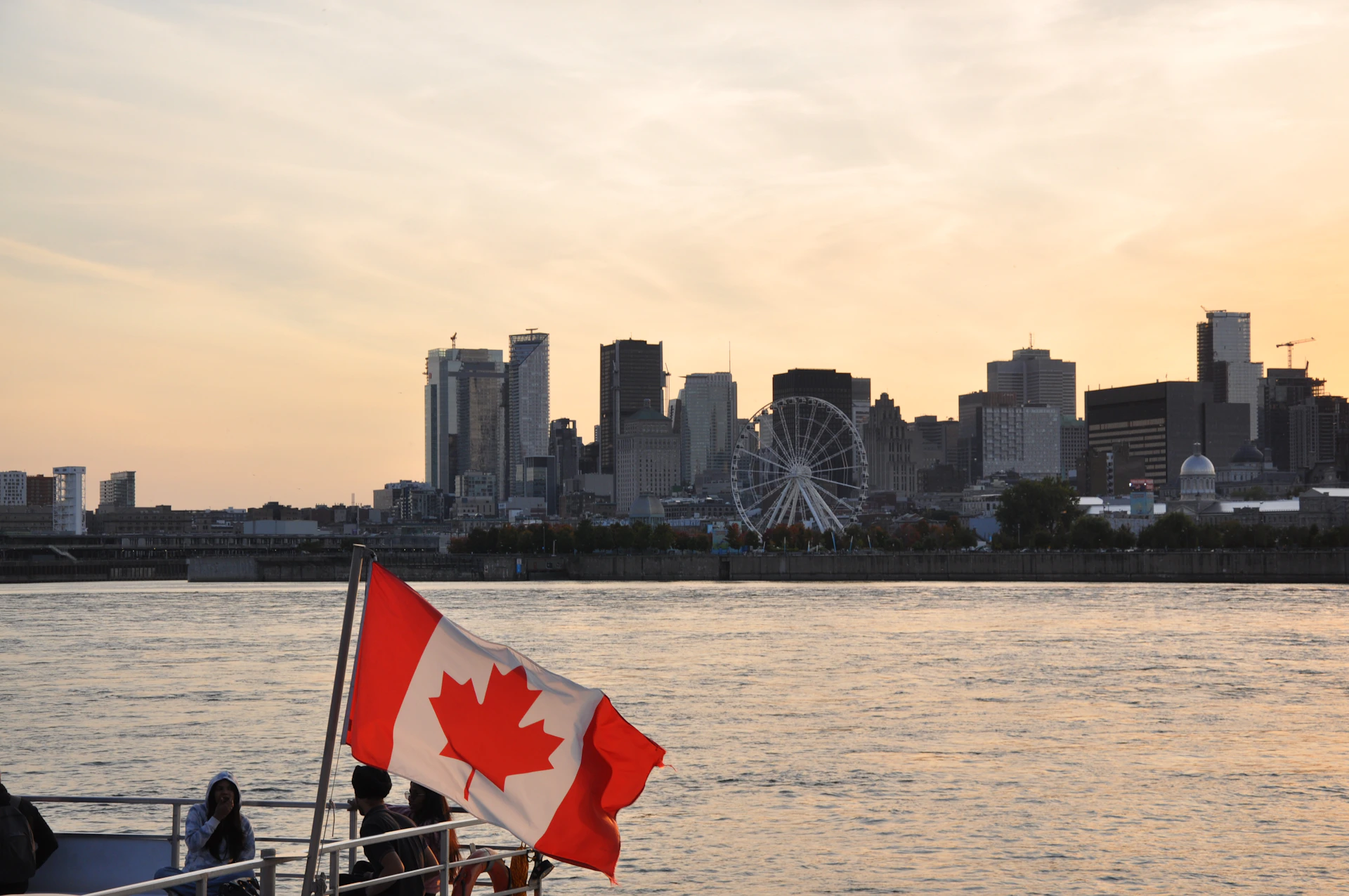 A canadian flag on a boat in the water