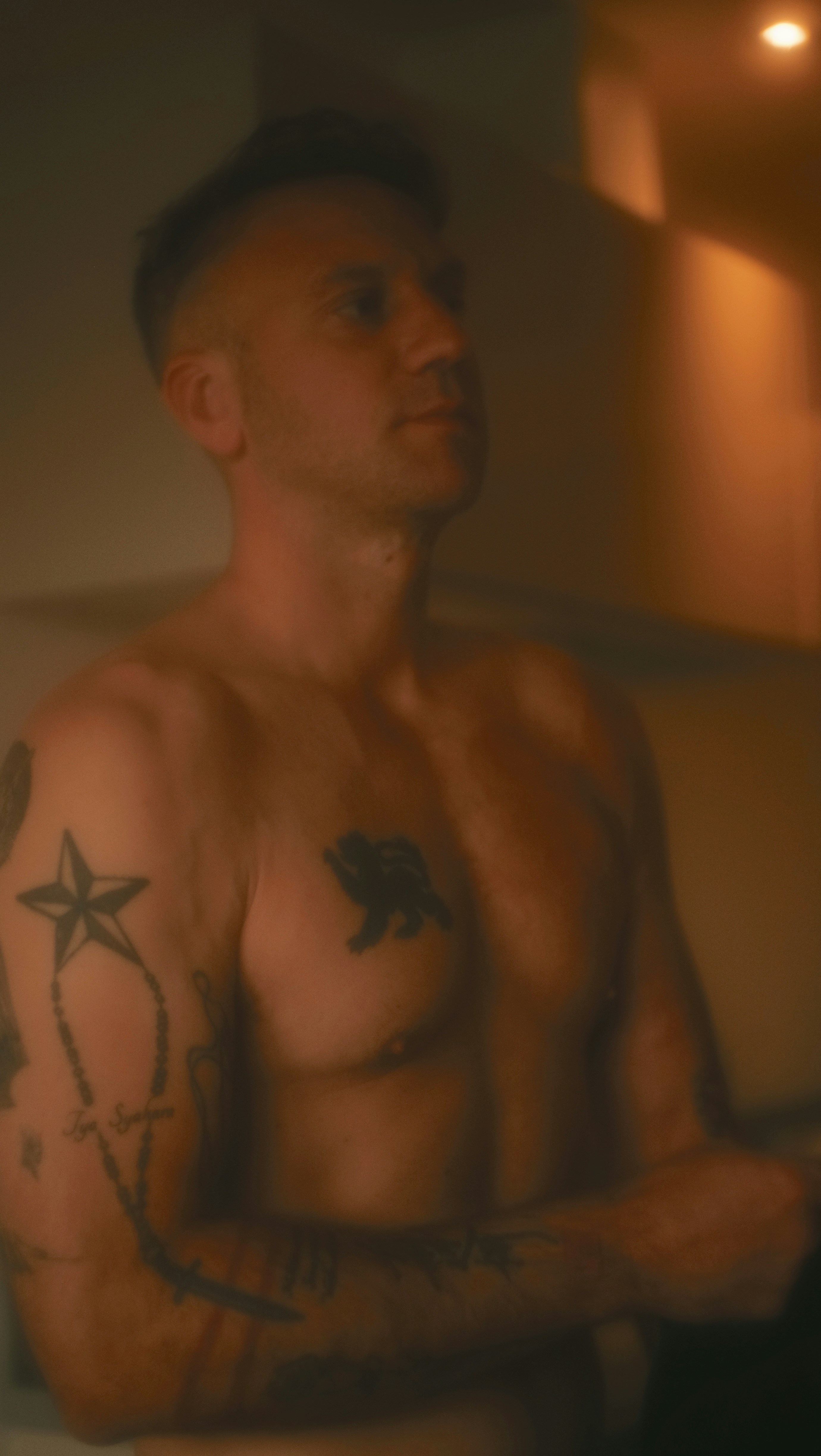 A man with a star tattoo on his chest