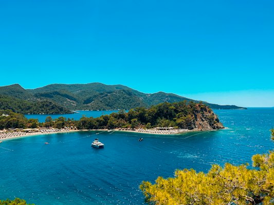 A view of a beach with a boat in the water — Kaş, Turkey