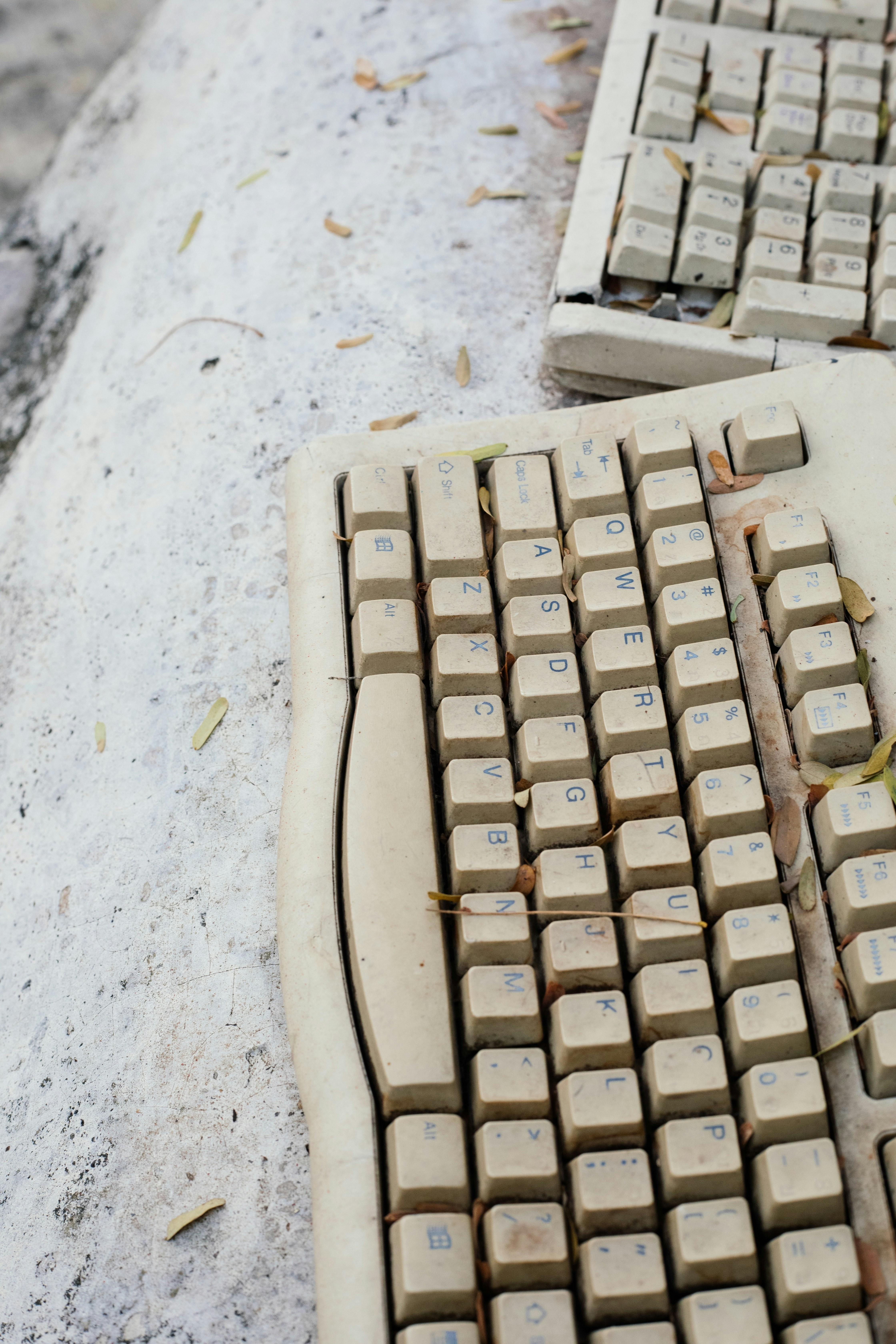 A computer keyboard sitting on top of a sidewalk