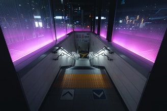 A train station with purple lights on the walls
